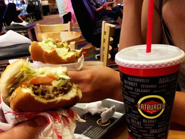 This image consists of tables and chairs. There are people at the top. In the middle there are...