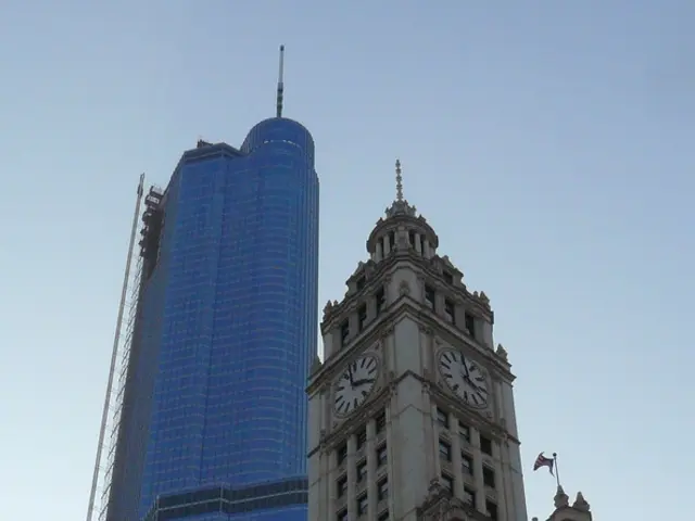 Here there are buildings with the windows, this is clock and a sky.