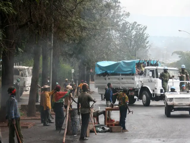 In the picture there are many workers and they are doing some work beside the road and there is a...