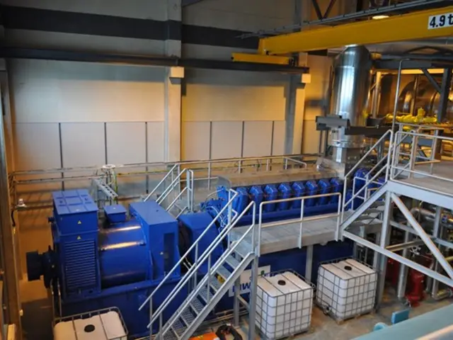 The picture is taken in a factory. In this picture there are carriers, staircase, railing,...